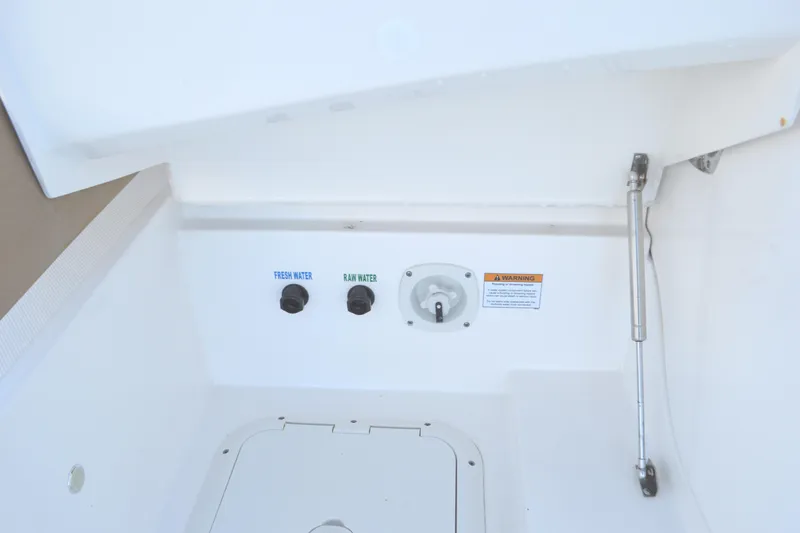 Slide: The Image of 2024 Tiara Yachts EX 60 water access panel with fresh and raw water controls. - 96