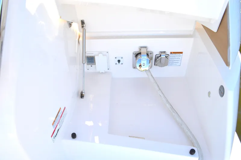 Slide: The Image of 2024 Tiara Yachts EX 60 utility compartment with power connections and safety warnings. - 97