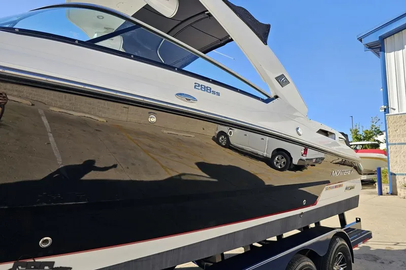 Slide: The Image of 2015 Monterey 288SS Super Sport boat on trailer, reflecting nearby vehicles. - 16