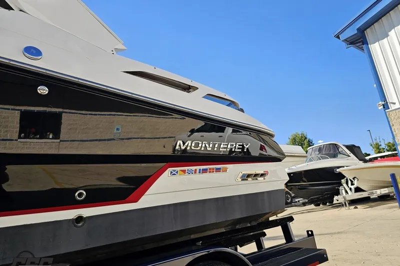 Slide: The Image of 2015 Monterey 288SS Super Sport boat in a marina, showcasing sleek design and vibrant colors. - 19