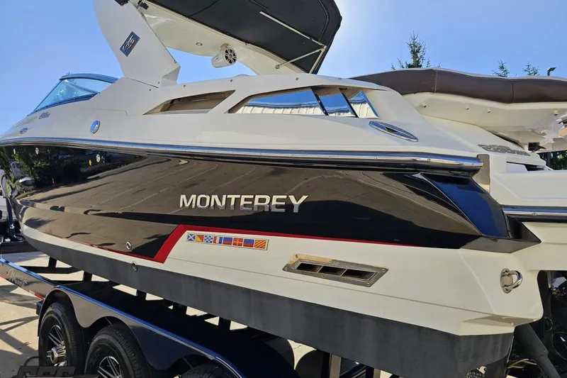 Slide: The Image of 2015 Monterey 288SS Super Sport boat on trailer, sleek black and white design. - 22