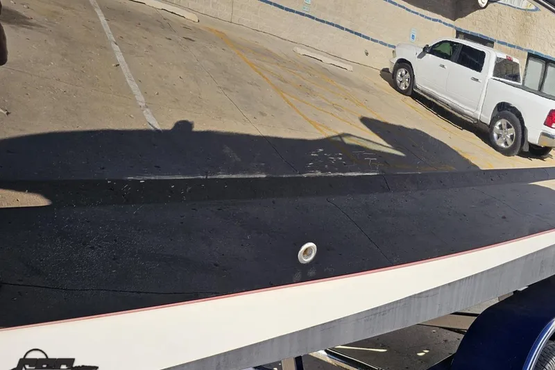 Slide: The Image of Reflection of a white truck on a 2015 Monterey 288SS Super Sport boat hull. - 24