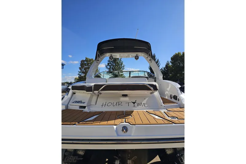 Slide: The Image of 2015 Monterey 288SS Super Sport boat with "Hour Tyme" on the stern, docked under clear skies. - 29