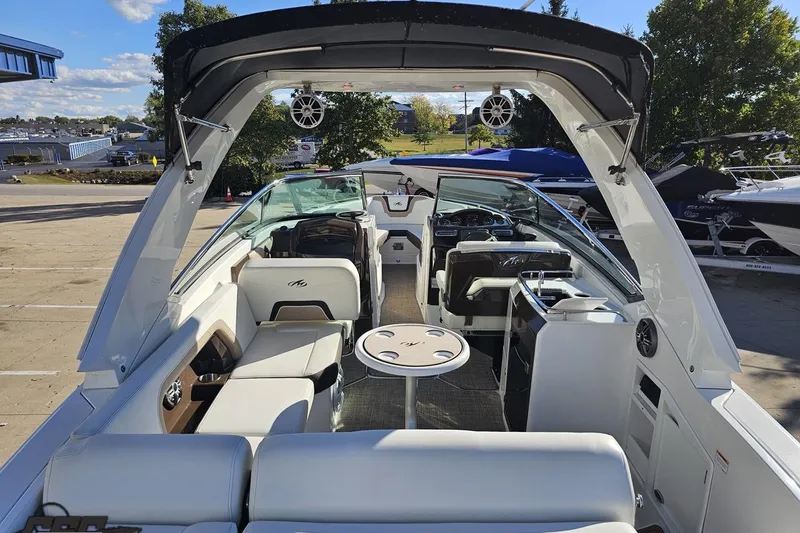 Slide: The Image of 2015 Monterey 288SS Super Sport boat interior with seating and helm, docked outdoors. - 37