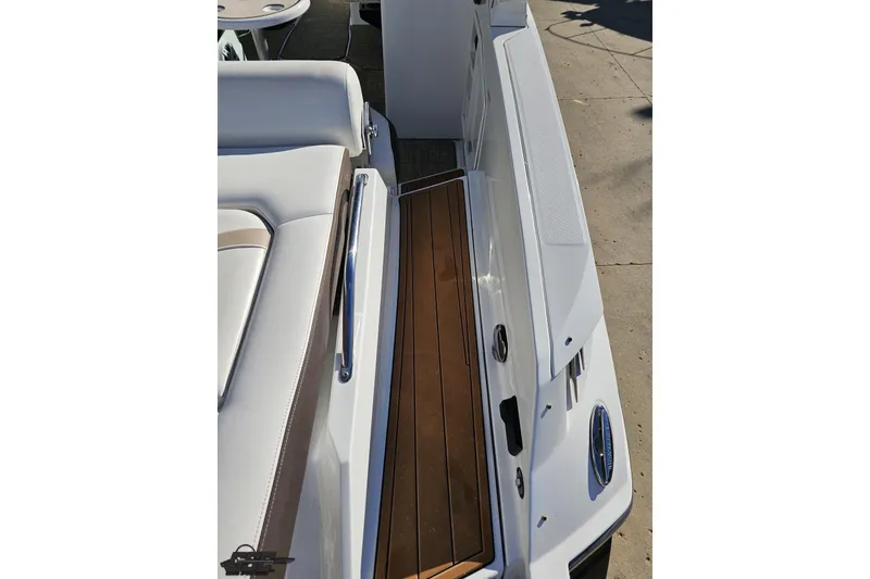 Slide: The Image of 2015 Monterey 288SS Super Sport boat interior with white seating and wooden flooring. - 38