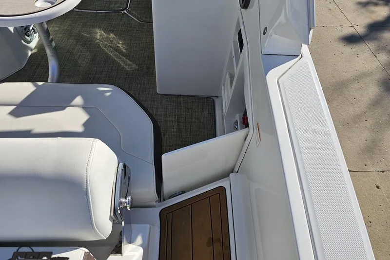Slide: The Image of Interior view of a 2015 Monterey 288SS Super Sport boat, featuring white seating and a table. - 40