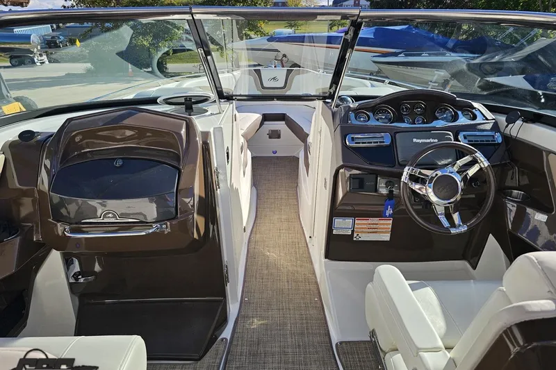Slide: The Image of Interior of a 2015 Monterey 288SS Super Sport boat with modern dashboard and steering wheel. - 51
