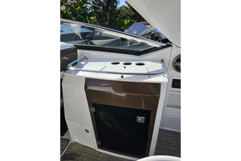 Slide: The Image of 2015 Monterey 288SS Super Sport boat interior with cup holders and storage compartment. - 54