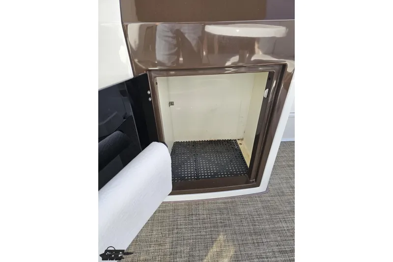Slide: The Image of Open storage compartment on 2015 Monterey 288SS Super Sport boat. - 56