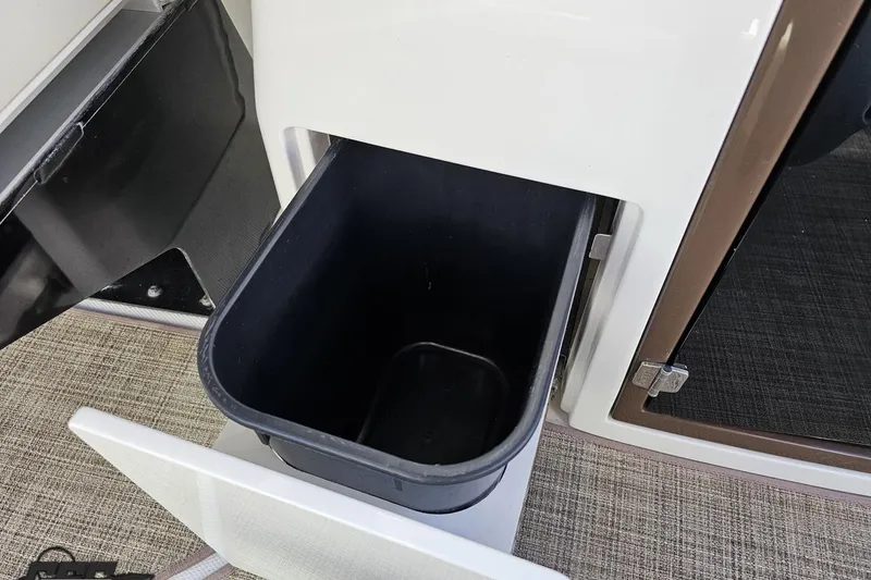 Slide: The Image of 2015 Monterey 288SS Super Sport boat interior with built-in trash compartment. - 57