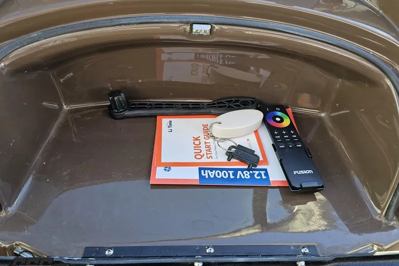 Slide: The Image of Storage compartment of a 2015 Monterey 288SS Super Sport with remote and manual. - 62