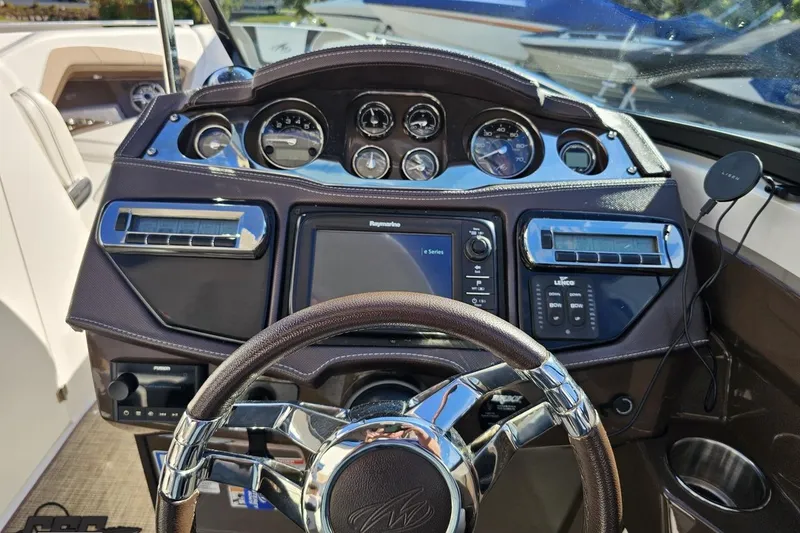 Slide: The Image of Dashboard of 2015 Monterey 288SS Super Sport boat with steering wheel and controls. - 70