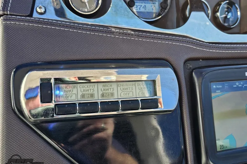 Slide: The Image of Control panel of a 2015 Monterey 288SS Super Sport boat with navigation and lighting controls. - 74