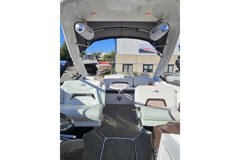 Slide: The Image of 2015 Monterey 288SS Super Sport boat interior with seating and canopy, docked outdoors. - 93