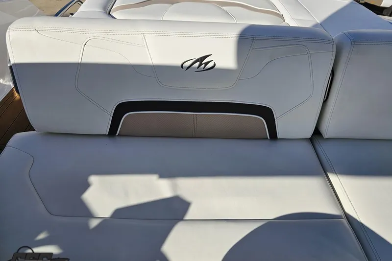 Slide: The Image of 2015 Monterey 288SS Super Sport boat seat with logo, white upholstery, and shadow. - 97