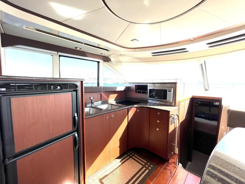 Slide: The Image of Luxurious interior of a 2012 Meridian 441 Sedan yacht with modern kitchen amenities. - 17