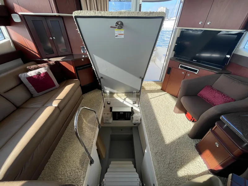 Slide: The Image of Interior of 2012 Meridian 441 Sedan yacht with open hatch, seating, and TV. - 21