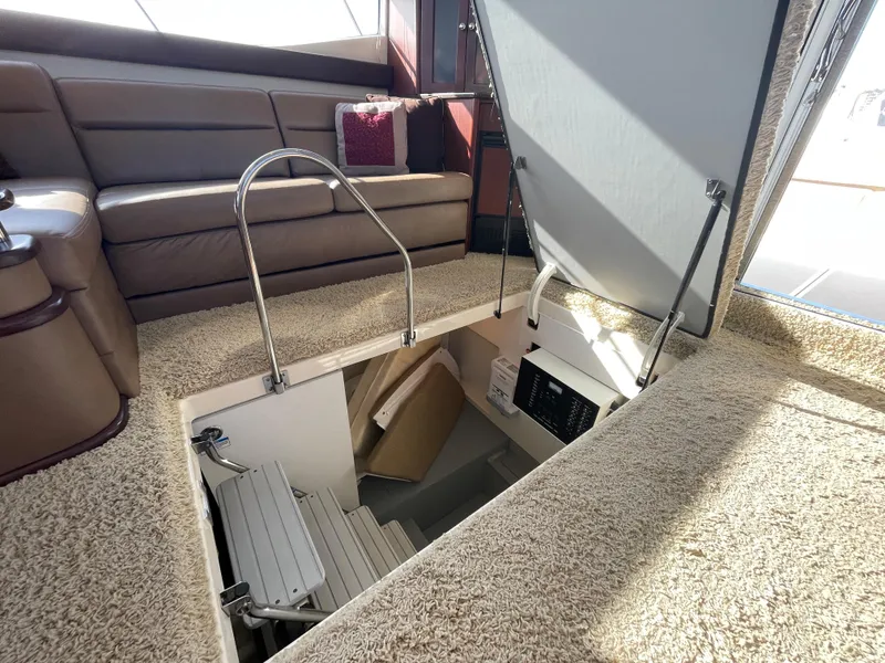 Slide: The Image of Interior of 2012 Meridian 441 Sedan yacht with open hatch and carpeted flooring. - 22