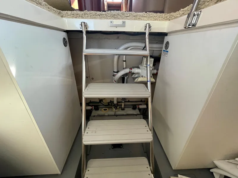 Slide: The Image of Staircase in 2012 Meridian 441 Sedan yacht, leading to engine room with visible piping. - 23