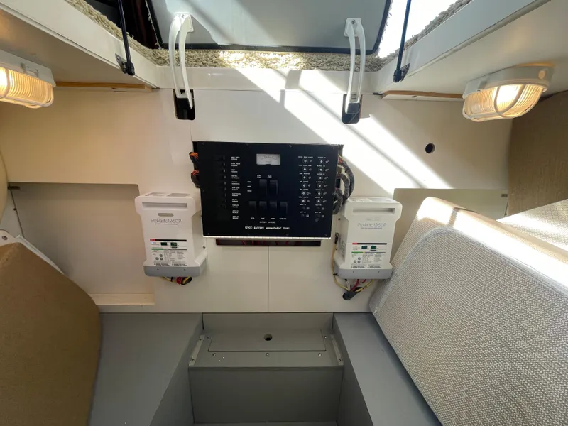 Slide: The Image of Electrical panel inside a 2012 Meridian 441 Sedan yacht, featuring circuit breakers and lighting. - 24