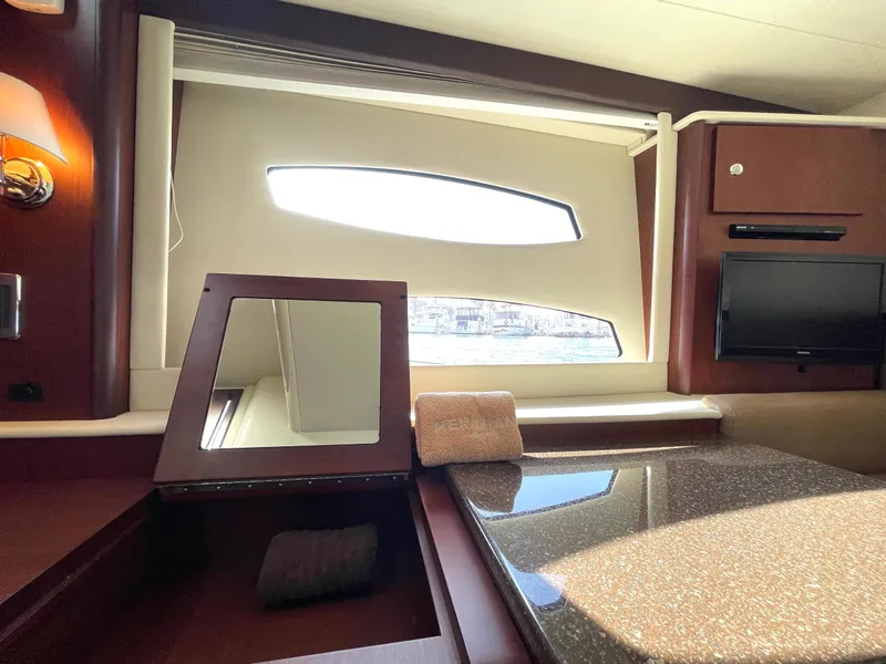 Slide: The Image of Interior of 2012 Meridian 441 Sedan yacht with window, mirror, and TV. - 32
