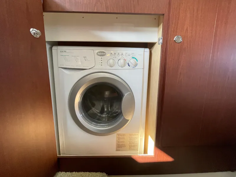 Slide: The Image of Compact washing machine installed in a 2012 Meridian 441 Sedan yacht interior. - 33