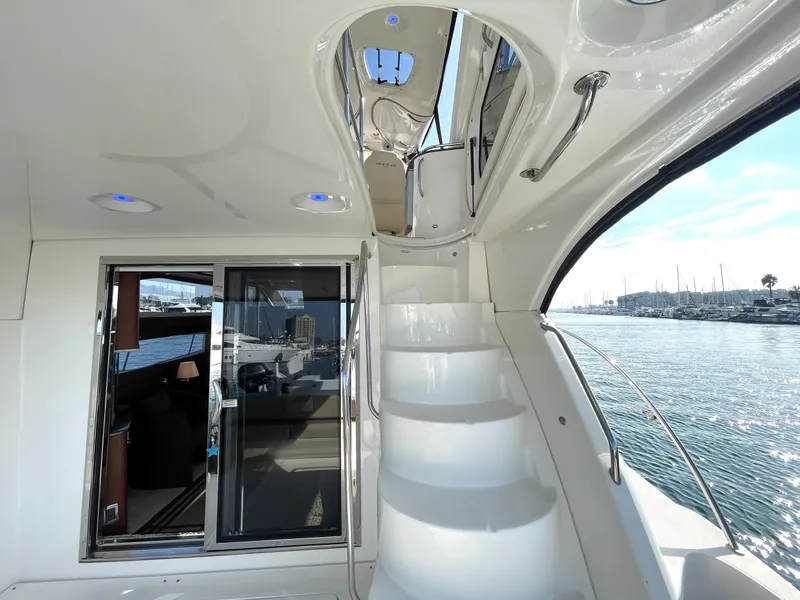 Slide: The Image of Interior view of 2012 Meridian 441 Sedan yacht with stairs and water backdrop. - 35