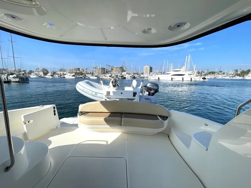 Slide: The Image of 2012 Meridian 441 Sedan yacht interior with marina view, featuring spacious seating and elegant design. - 36