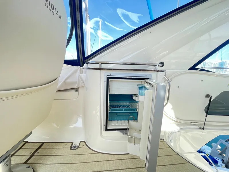 Slide: The Image of 2012 Meridian 441 Sedan interior with open mini fridge and seating area. - 38