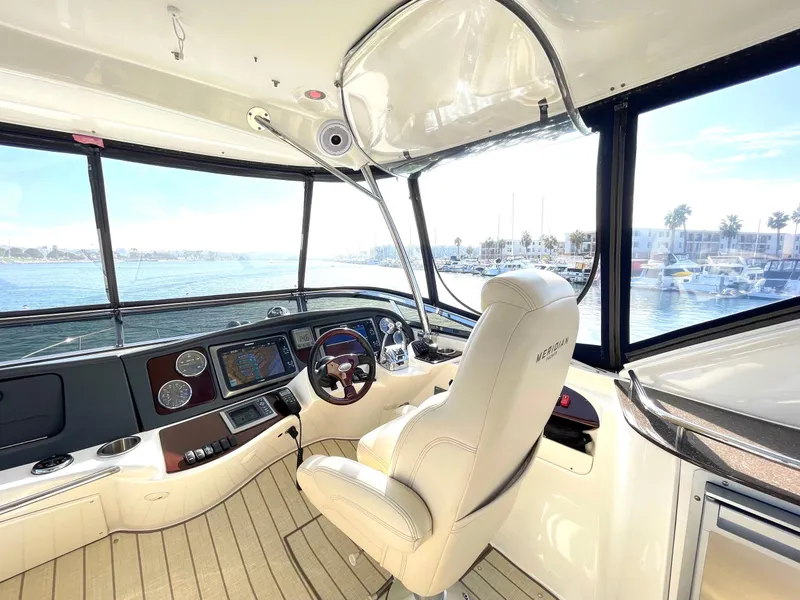 Slide: The Image of Interior view of 2012 Meridian 441 Sedan yacht cockpit with steering wheel and navigation controls. - 47