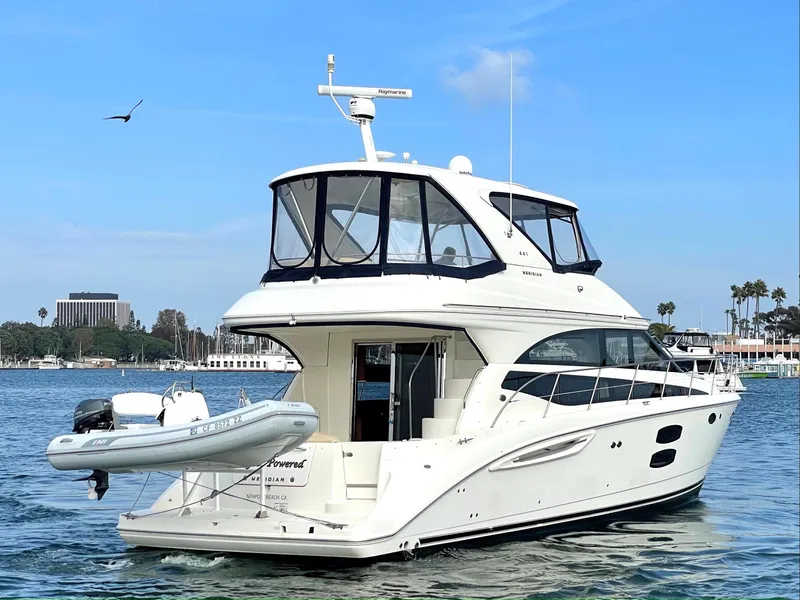 Slide: The Image of 2012 Meridian 441 Sedan yacht on calm water with a clear sky backdrop. - 5