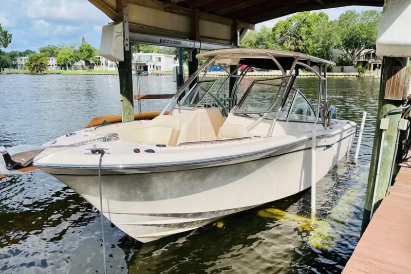 The Image of 2014 Grady-White Freedom 275 boat docked under a covered structure on a sunny day. - 0