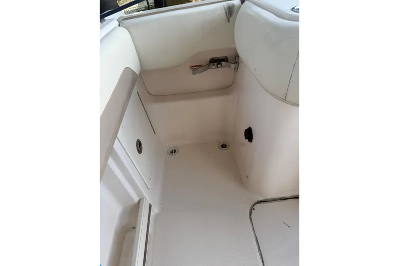 Slide: The Image of Interior view of a 2014 Grady-White Freedom 275 boat, featuring white seating and storage. - 15