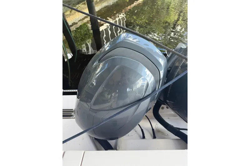 Slide: The Image of 2014 Grady-White Freedom 275 boat engine, docked by water. - 16