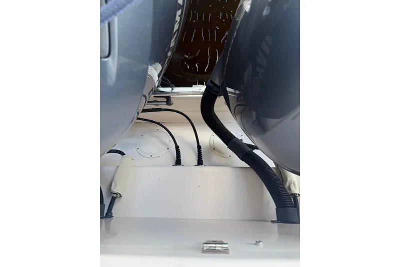 Slide: The Image of 2014 Grady-White Freedom 275 boat engine compartment with cables and hoses. - 18