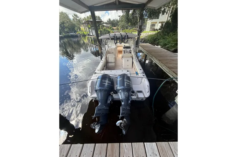 Slide: The Image of 2014 Grady-White Freedom 275 boat docked with dual Yamaha outboard engines. - 2