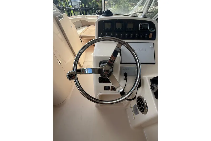 Slide: The Image of Steering wheel and dashboard of 2014 Grady-White Freedom 275 boat. - 27