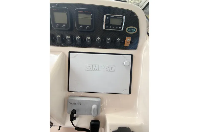 Slide: The Image of 2014 Grady-White Freedom 275 dashboard with Simrad and Garmin electronics. - 30