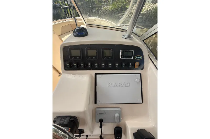 Slide: The Image of 2014 Grady-White Freedom 275 boat dashboard with Simrad and Garmin electronics. - 31