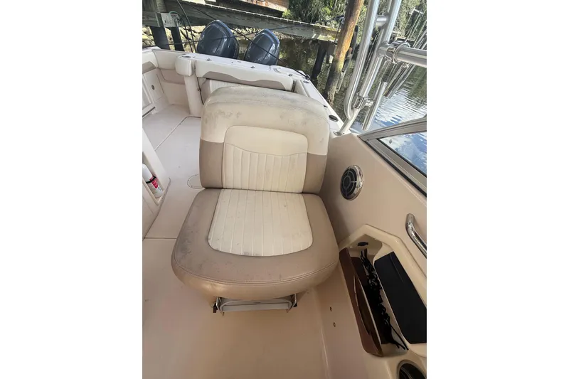 Slide: The Image of 2014 Grady-White Freedom 275 boat interior with cushioned seating and water view. - 35