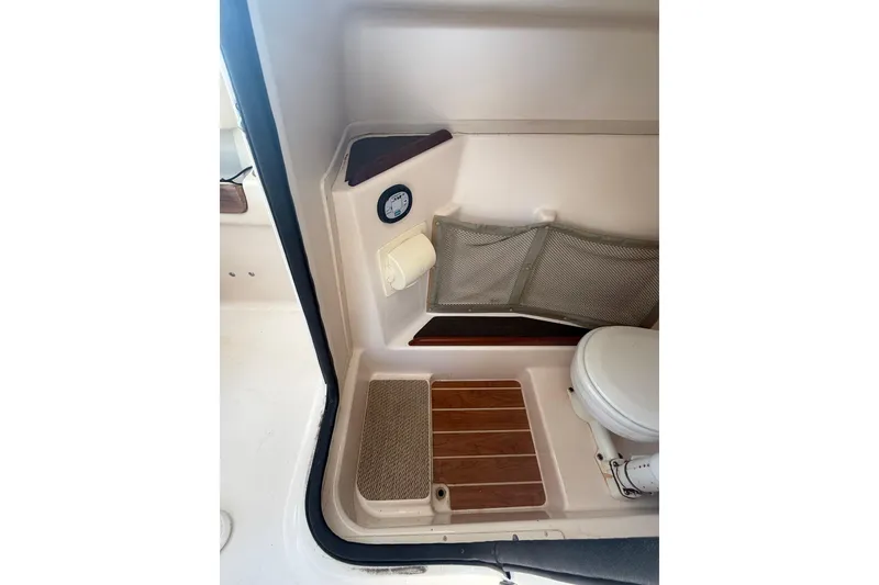 Slide: The Image of 2014 Grady-White Freedom 275 boat interior with toilet and storage area. - 38