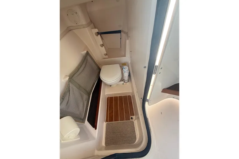Slide: The Image of 2014 Grady-White Freedom 275 boat interior with toilet and storage area. - 39