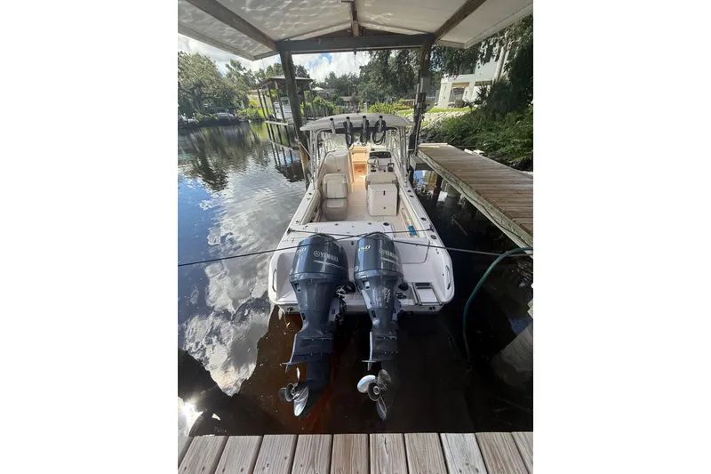 Slide: The Image of 2014 Grady-White Freedom 275 boat docked with dual Yamaha engines. - 4