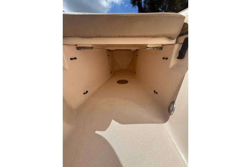 Slide: The Image of 2014 Grady-White Freedom 275 boat interior storage compartment, beige upholstery, open hatch. - 44