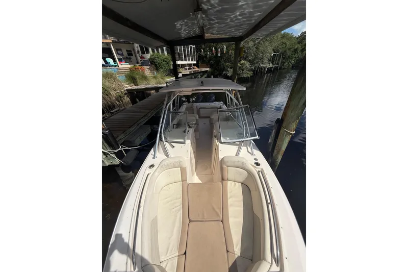 Slide: The Image of 2014 Grady-White Freedom 275 boat docked, featuring spacious seating and sleek design. - 46