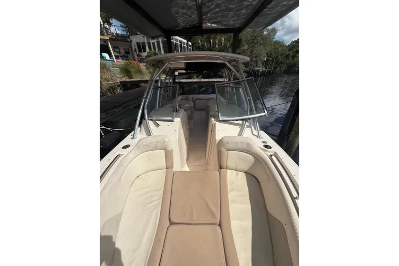 Slide: The Image of 2014 Grady-White Freedom 275 boat interior with seating and open windshield. - 48
