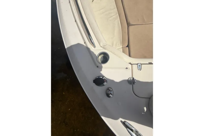 Slide: The Image of 2014 Grady-White Freedom 275 boat interior with beige seating and metal fixtures. - 49