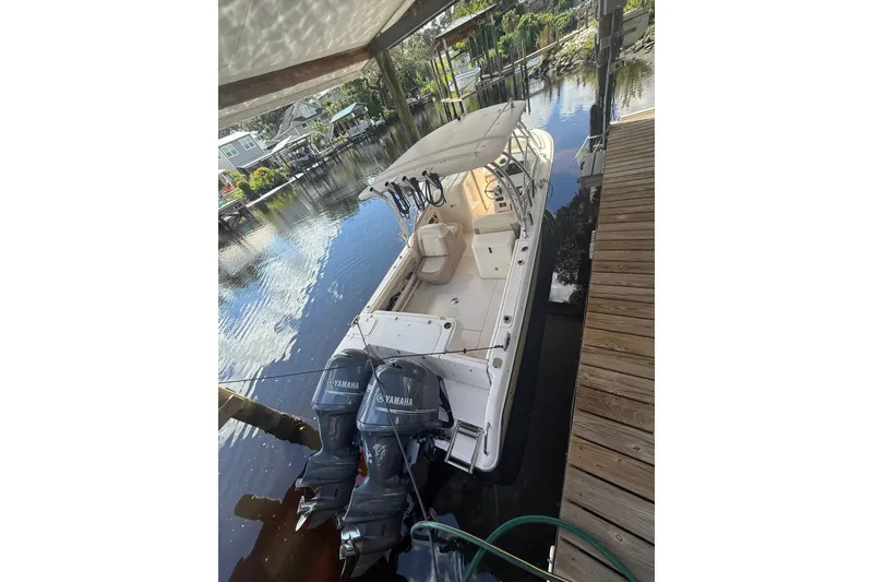 Slide: The Image of 2014 Grady-White Freedom 275 boat docked with twin Yamaha engines. - 5