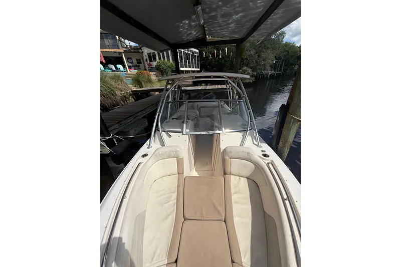 Slide: The Image of 2014 Grady-White Freedom 275 boat docked, featuring spacious seating and sleek design. - 53