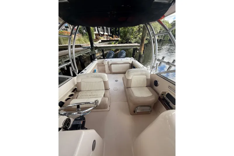 Slide: The Image of 2014 Grady-White Freedom 275 boat interior with seating and steering wheel. - 55